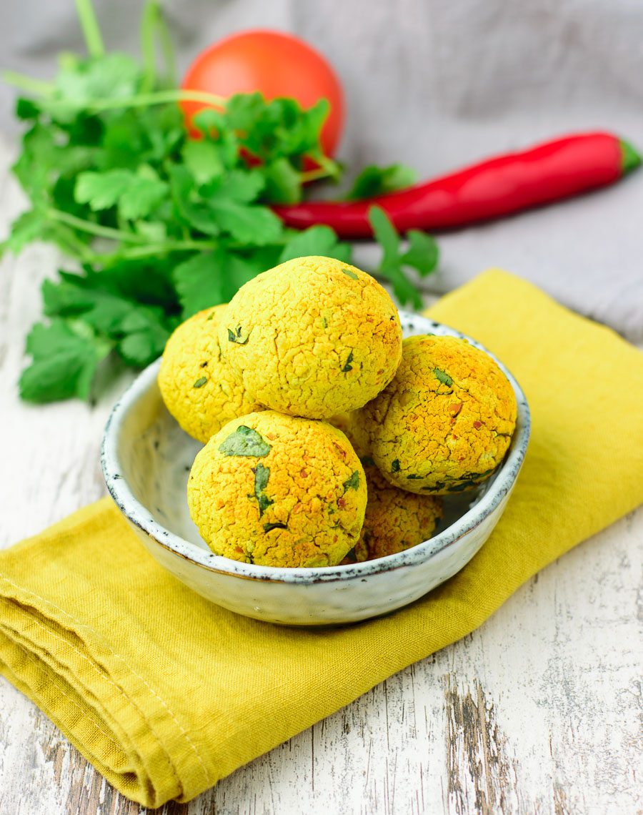 Small bowl with five turmeric falafel balls.