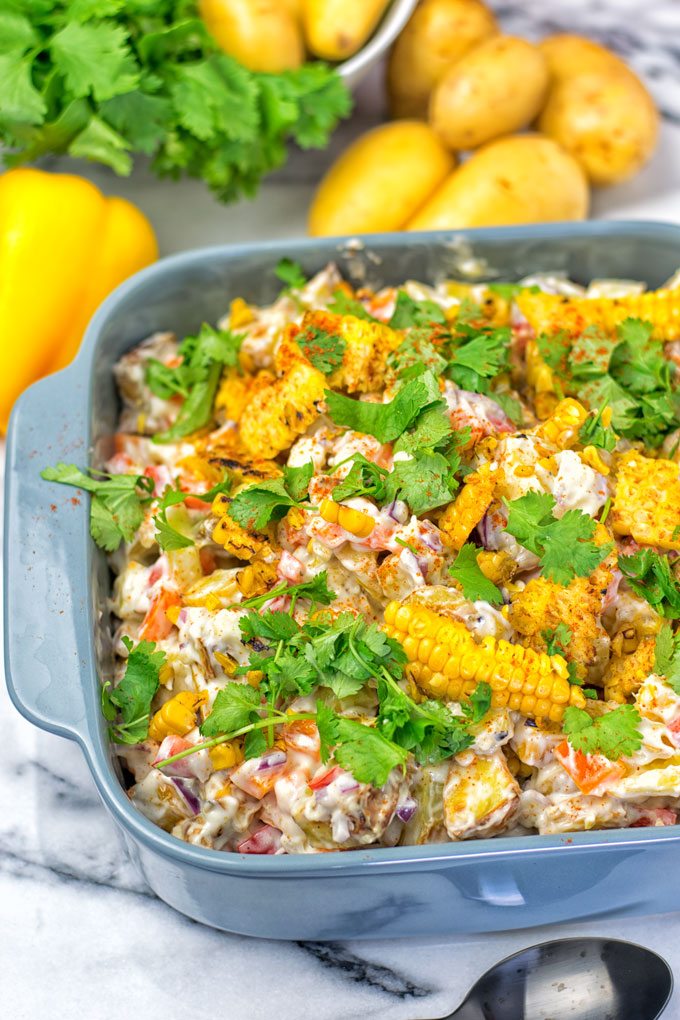 A dish filled with the Mexican Street Corn Potato Salad