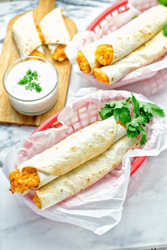 These Buffalo Cauliflower Taquitos are the ultimate comfort food. Vegan, gluten free, super easy to make and insanely delicious. An amazing dairy free alternative for dinner, lunch, potluck, party, meal prep, work lunch option. Once you'll try these, they will go into your daily rotation. #vegan #glutenfree #vegetarian #dairyfree #plantbased #contentednesscooking #lunch #dinner #mealprep #worklunchideas #taquitos #buffalocauliflower #easyfood #budgetfriendly #makeahedmeals #cauliflower
