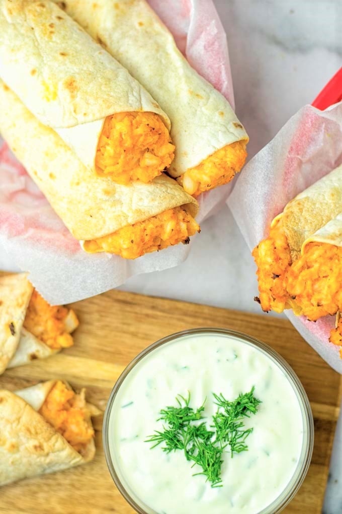 These Buffalo Cauliflower Taquitos are the ultimate comfort food. Vegan, gluten free, super easy to make and insanely delicious. An amazing dairy free alternative for dinner, lunch, potluck, party, meal prep, work lunch option. Once you'll try these, they will go into your daily rotation. #vegan #glutenfree #vegetarian #dairyfree #plantbased #contentednesscooking #lunch #dinner #mealprep #worklunchideas #taquitos #buffalocauliflower #easyfood #budgetfriendly #makeahedmeals #cauliflower