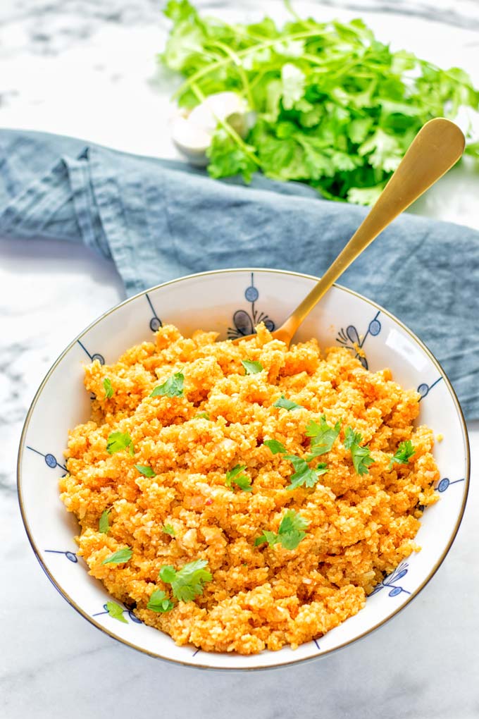 This Spanish Cauliflower Rice is naturally vegan, gluten free and seriously the best. It's super easy to make in one pan and packed with amazing flavors. An easy recipe for lunch, dinner, meal prep and work lunch. It's delicious on its own or as side dish. Try this great dairy free and low carb alternative now. #vegan #glutenfree #dairyfree #vegetarian #cauliflower #spanish #rice #lowcarb #mealprep #worklunchideas #lunch #dinner #sidedish #contentednesscooking #easyfood #budgetmeals