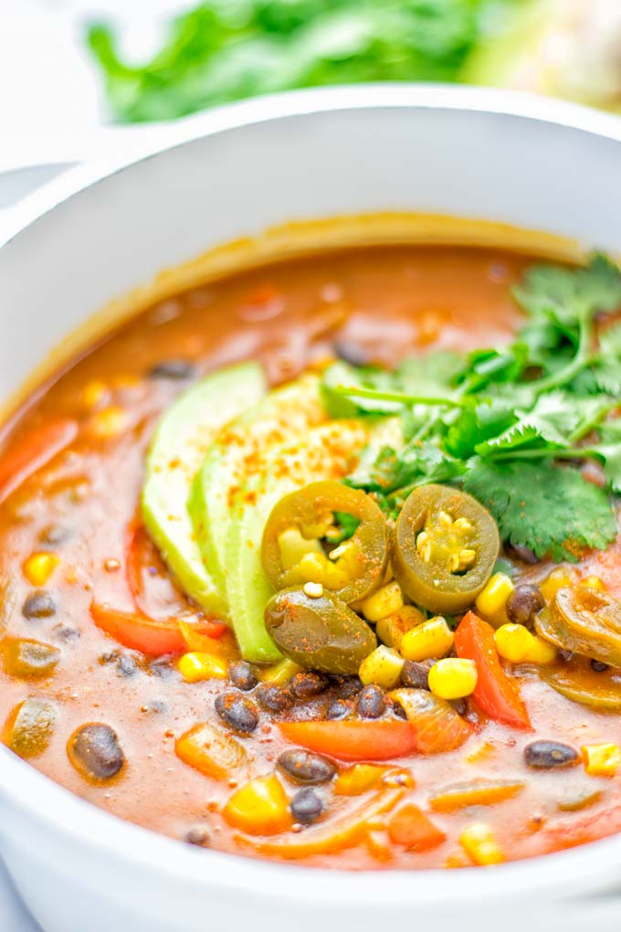 This Spicy Garlic Enchilada Soup is made in one pot, insanely delicious and super easy to make. Naturally vegan, gluten free and amazing for dinner, lunch, meal prep and work lunch. Try it now you won't believe how easy it is! #vegan #glutenfree #dairyfree # vegetarian #enchilada #soup #dinner #lunch #mealprep #worklunchideas #onepotmeals #enchiladasoup #contentednesscooking