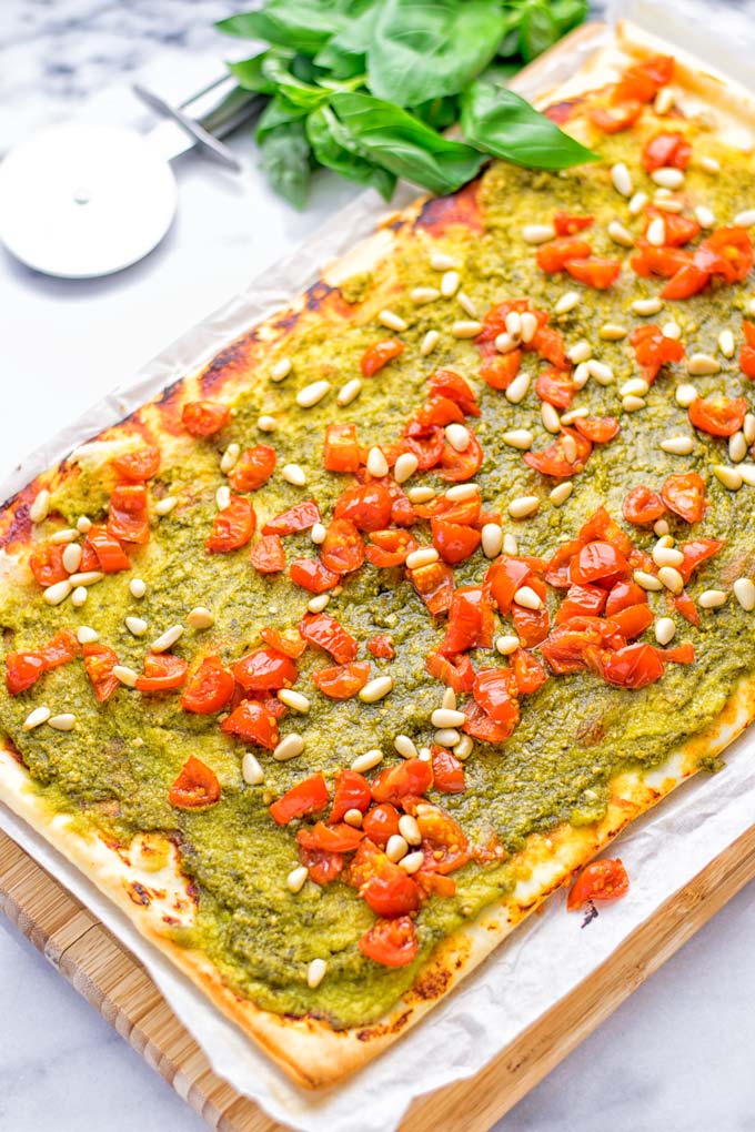 This White Bean and Pesto Pizza is super easy to make, entirely vegan and gluten free. If you love pizza and pesto you're coming to the right place. It's so delicious for lunch, dinner, meal preparation, and work lunch. Try it now and fall in love. #vegan #glutenfree #dairyfree #contentednesscooking #pesto #pizza #mealprep #worklunchideas #easyfood #lunch #dinner