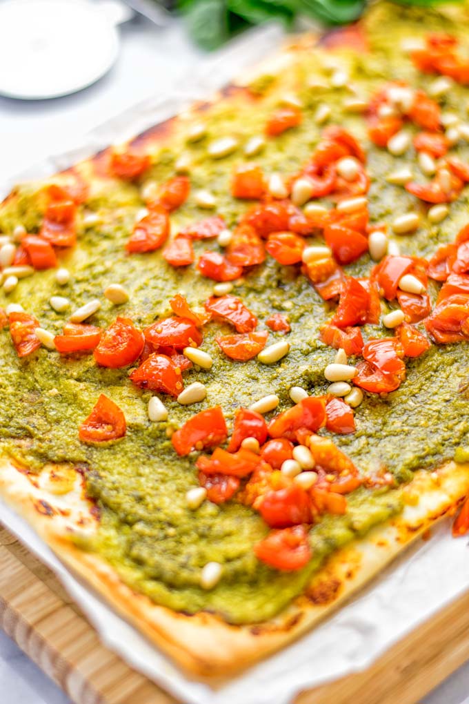 This White Bean and Pesto Pizza is super easy to make, entirely vegan and gluten free. If you love pizza and pesto you're coming to the right place. It's so delicious for lunch, dinner, meal preparation, and work lunch. Try it now and fall in love. #vegan #glutenfree #dairyfree #contentednesscooking #pesto #pizza #mealprep #worklunchideas #easyfood #lunch #dinner