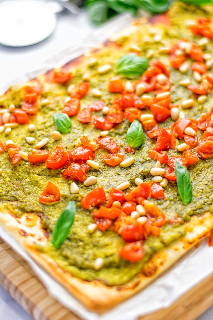 This White Bean and Pesto Pizza is super easy to make, entirely vegan and gluten free. If you love pizza and pesto you're coming to the right place. It's so delicious for lunch, dinner, meal preparation, and work lunch. Try it now and fall in love. #vegan #glutenfree #dairyfree #contentednesscooking #pesto #pizza #mealprep #worklunchideas #easyfood #lunch #dinner