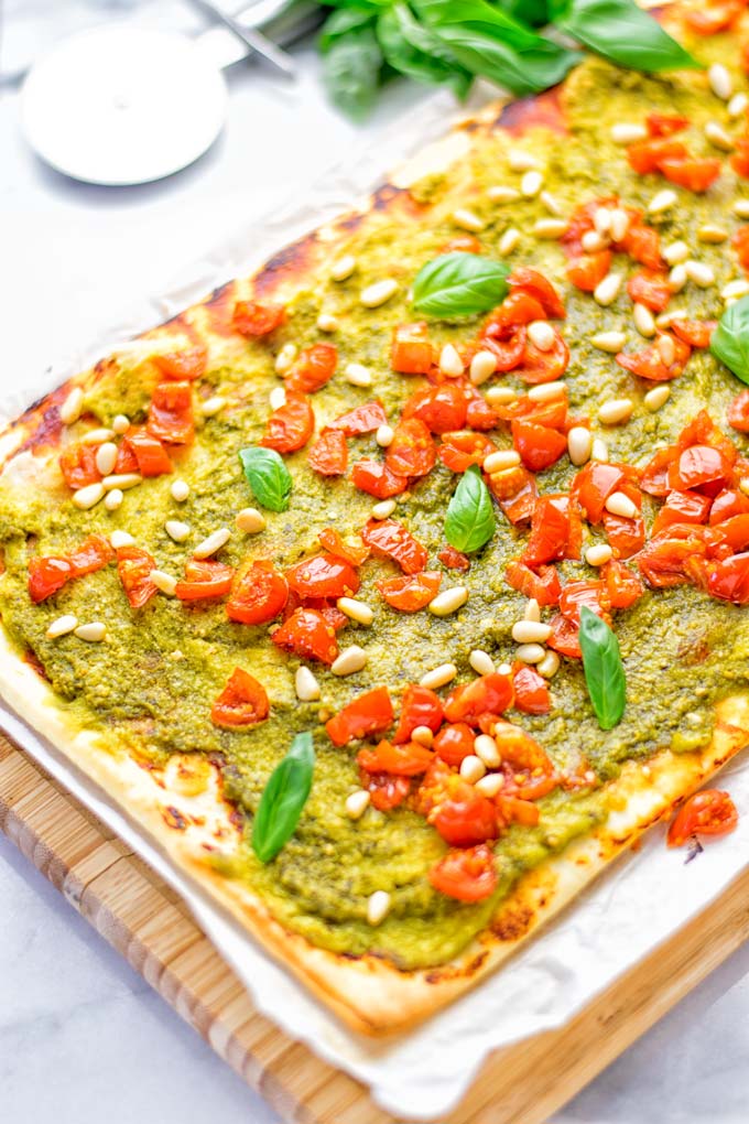 This White Bean and Pesto Pizza is super easy to make, entirely vegan and gluten free. If you love pizza and pesto you're coming to the right place. It's so delicious for lunch, dinner, meal preparation, and work lunch. Try it now and fall in love. #vegan #glutenfree #dairyfree #contentednesscooking #pesto #pizza #mealprep #worklunchideas #easyfood #lunch #dinner