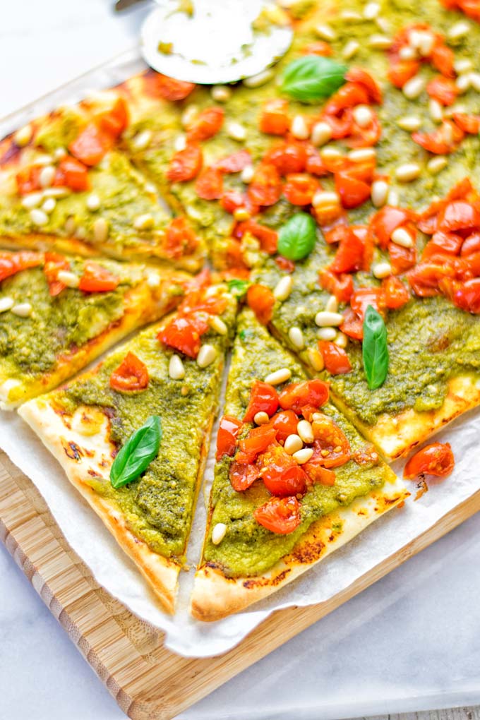 This White Bean and Pesto Pizza is super easy to make, entirely vegan and gluten free. If you love pizza and pesto you're coming to the right place. It's so delicious for lunch, dinner, meal preparation, and work lunch. Try it now and fall in love. #vegan #glutenfree #dairyfree #contentednesscooking #pesto #pizza #mealprep #worklunchideas #easyfood #lunch #dinner