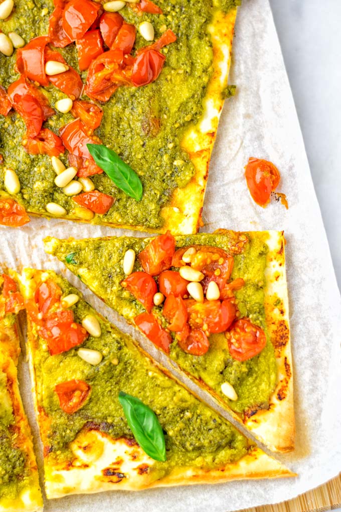 This White Bean and Pesto Pizza is super easy to make, entirely vegan and gluten free. If you love pizza and pesto you're coming to the right place. It's so delicious for lunch, dinner, meal preparation, and work lunch. Try it now and fall in love. #vegan #glutenfree #dairyfree #contentednesscooking #pesto #pizza #mealprep #worklunchideas #easyfood #lunch #dinner