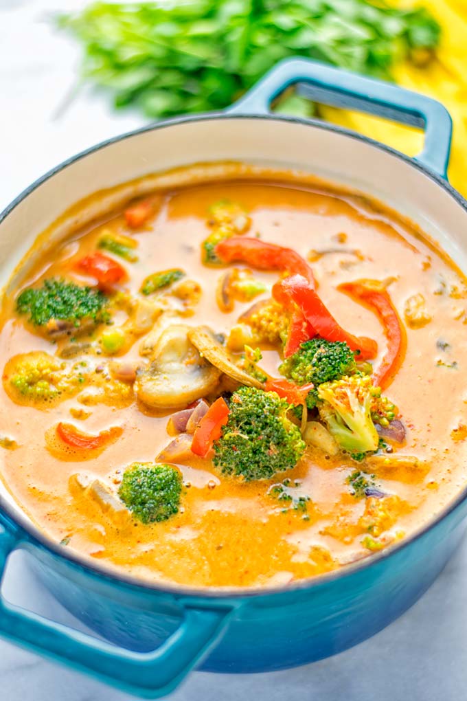 This Red Curry Coconut Soup is a super easy one pot meal and packed with such amazing flavors. It's creamy and naturally vegan, gluten free. It's an amazing dairy free alternative for lunch, dinner, meal preparation, that the whole family will love, or work lunches. Try it now and know how ridiculously easy delicious food can be. #vegan #glutenfree #dairyfree #contentednesscooking #dinner #lunch #onepotmeals #dairyfree #worklunchideas #curry #easyfood #vegetarian #soup #mealprep
