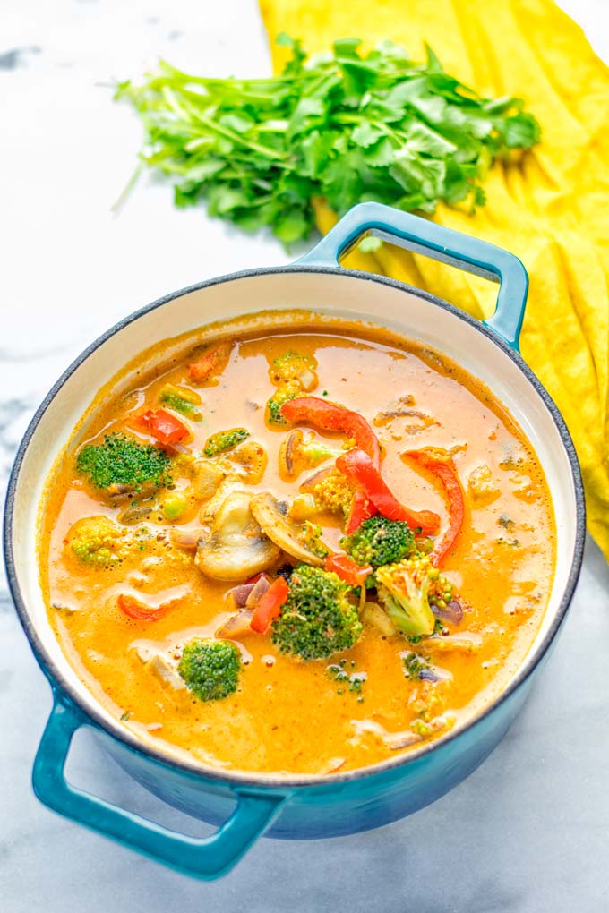 This Red Curry Coconut Soup is a super easy one pot meal and packed with such amazing flavors. It's creamy and naturally vegan, gluten free. It's an amazing dairy free alternative for lunch, dinner, meal preparation, that the whole family will love, or work lunches. Try it now and know how ridiculously easy delicious food can be. #vegan #glutenfree #dairyfree #contentednesscooking #dinner #lunch #onepotmeals #dairyfree #worklunchideas #curry #easyfood #vegetarian #soup #mealprep