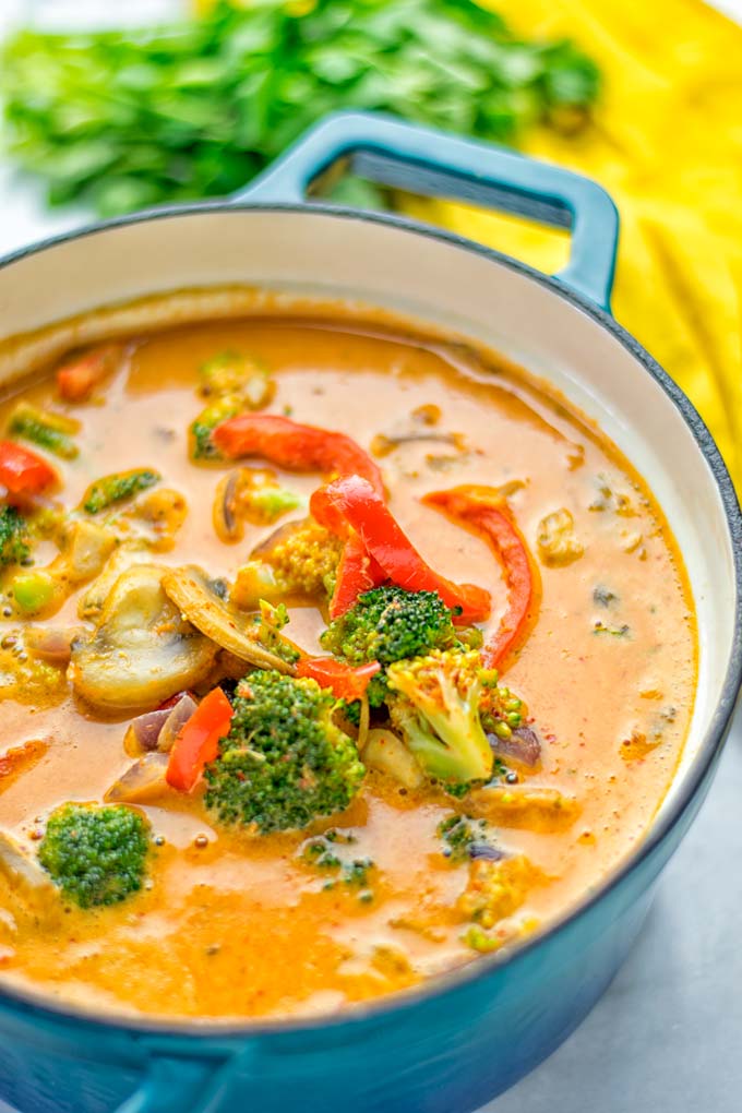 This Red Curry Coconut Soup is a super easy one pot meal and packed with such amazing flavors. It's creamy and naturally vegan, gluten free. It's an amazing dairy free alternative for lunch, dinner, meal preparation, that the whole family will love, or work lunches. Try it now and know how ridiculously easy delicious food can be. #vegan #glutenfree #dairyfree #contentednesscooking #dinner #lunch #onepotmeals #dairyfree #worklunchideas #curry #easyfood #vegetarian #soup #mealprep