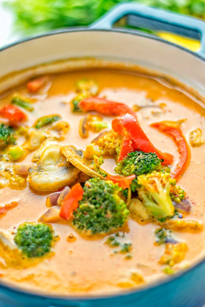 This Red Curry Coconut Soup is a super easy one pot meal and packed with such amazing flavors. It's creamy and naturally vegan, gluten free. It's an amazing dairy free alternative for lunch, dinner, meal preparation, that the whole family will love, or work lunches. Try it now and know how ridiculously easy delicious food can be. #vegan #glutenfree #dairyfree #contentednesscooking #dinner #lunch #onepotmeals #dairyfree #worklunchideas #curry #easyfood #vegetarian #soup #mealprep
