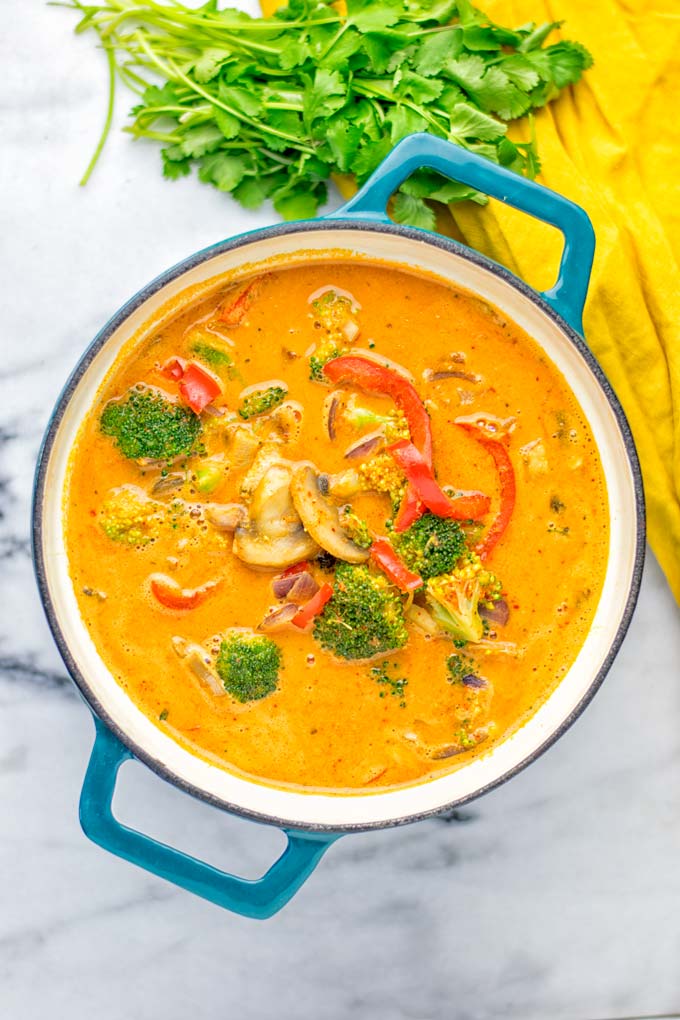 This Red Curry Coconut Soup is a super easy one pot meal and packed with such amazing flavors. It's creamy and naturally vegan, gluten free. It's an amazing dairy free alternative for lunch, dinner, meal preparation, that the whole family will love, or work lunches. Try it now and know how ridiculously easy delicious food can be. #vegan #glutenfree #dairyfree #contentednesscooking #dinner #lunch #onepotmeals #dairyfree #worklunchideas #curry #easyfood #vegetarian #soup #mealprep
