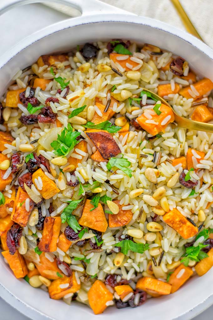 This Wild Rice Pilaf is a super easy and tasty one pot meal. Naturally vegan, gluten free it has all the flavors you love and want for Christmas and the whole year. Try it now for dinner, lunch, meal prep, wow your guests and family. #vegan #glutenfree #dairyfree #vegetarian #christmasfood #dinner #lunch #onepotmeals #holidayfood #wildricepilaf #ricepilafeasy #worklunchideas #contentednesscooking #mealprep
