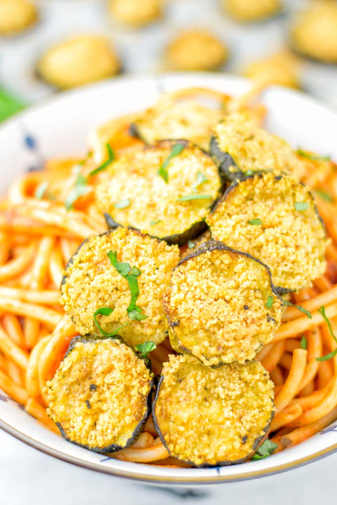 This Baked Zucchini Parmesan is entirely vegan, gluten free and will be a family favorite. Serve it with pasta, dips, as appetizer, dinner, lunches, meal preparation, or work lunch. Sprinkled with the best dairy free parmesan cheese that makes all the difference. Try it now. #vegan #dairyfree #vegetarian #contentednesscooking #dinner #lunch #mealprep #worklunchideas #zucchiniparmesan #zucchiniparmesanbaked #zucchiniparmesancrisps #comfortfood #kidfriendlydinners #familydinnerideas