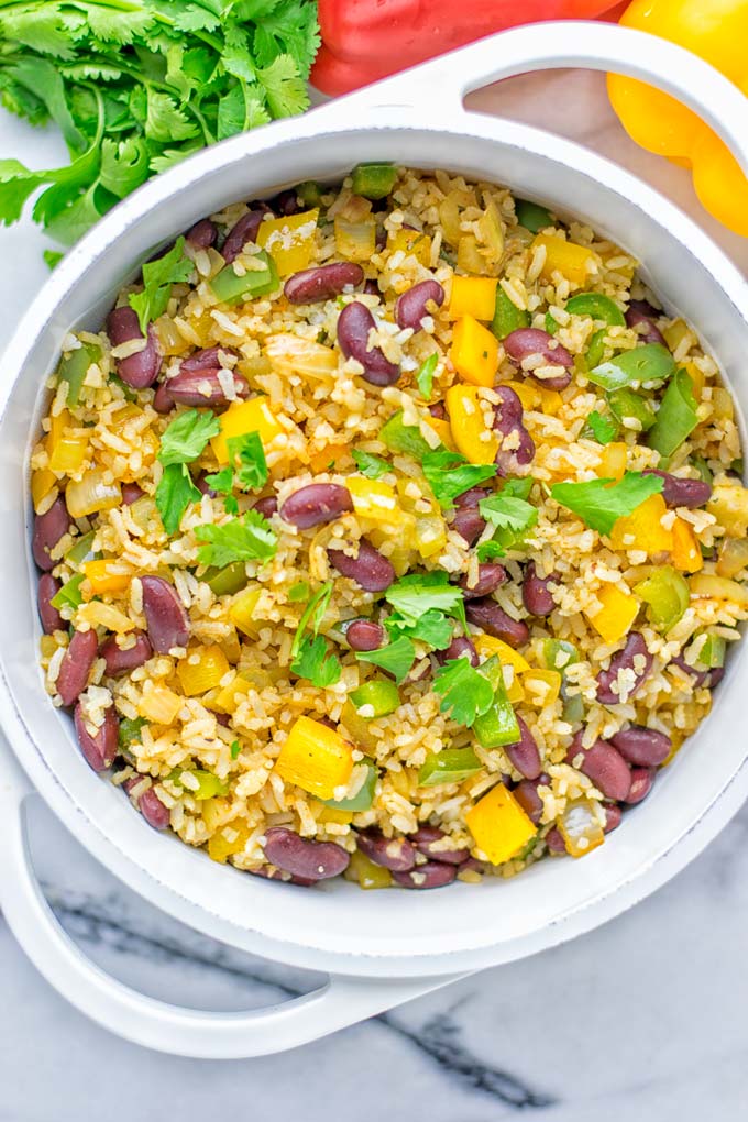 This Cajun Red Beans and Rice is an amazing one pot meal which is naturally vegan, gluten free. It's packed with bold and fantastic flavors the whole family will love for dinner, lunch, meal prep and work lunch and so much more. Once you've tried this you can't stop eating it so easy to make! #vegan #dairyfree #glutenfree #vegetarian #onepotmeals #dinner #lunch #worklunchideas #budgetmeals #contentednesscooking #cajunbeansandrice #mealprep