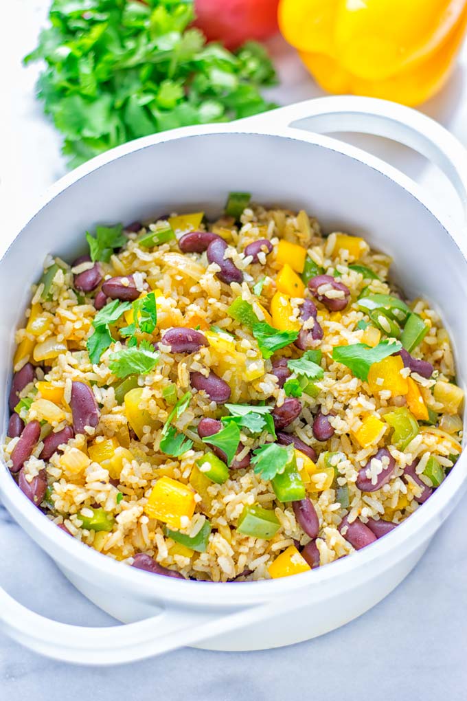 This Cajun Red Beans and Rice is an amazing one pot meal which is naturally vegan, gluten free. It's packed with bold and fantastic flavors the whole family will love for dinner, lunch, meal prep and work lunch and so much more. Once you've tried this you can't stop eating it so easy to make! #vegan #dairyfree #glutenfree #vegetarian #onepotmeals #dinner #lunch #worklunchideas #budgetmeals #contentednesscooking #cajunbeansandrice #mealprep