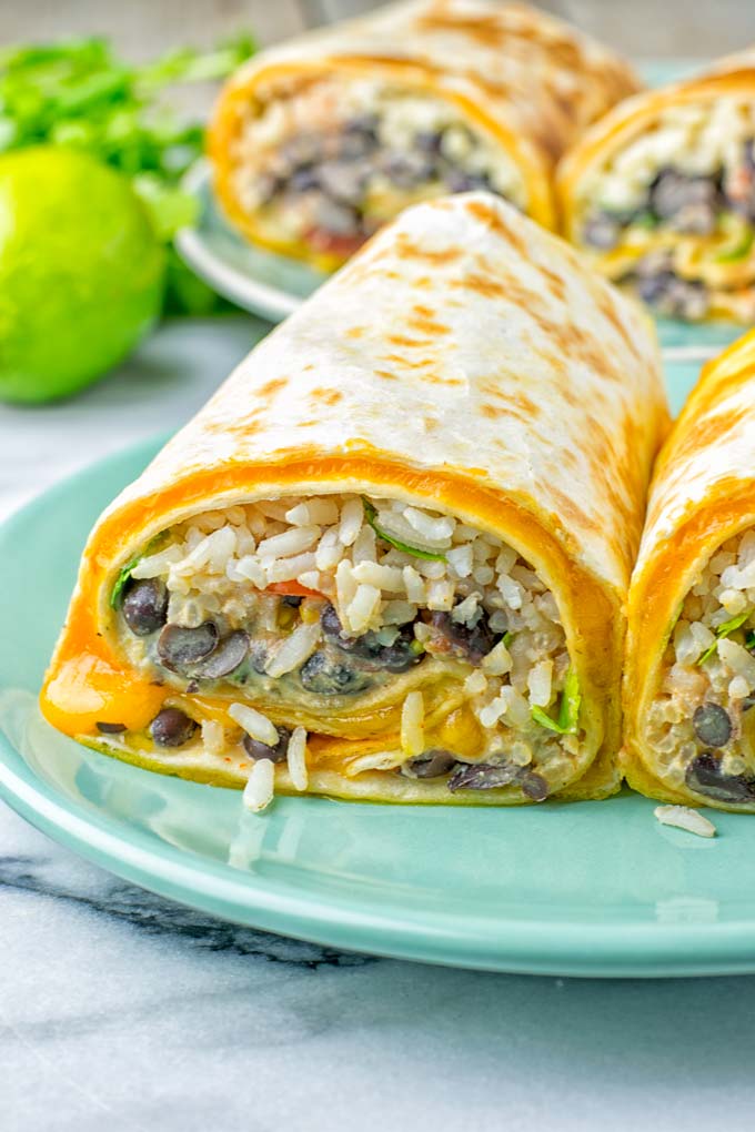 This Rice and Beans Quesarito is entirelly vegan, gluten free and so easy to make. It's cheesy, incredibly satisfying and so delicious for dinner, lunch, meal prep (reheat beautifully) and amazing for work lunches. An amazing dairy free alternative for everyone that the whole family will love. #vegan #glutenfree #dairyfree #vegetarian #contentednesscooking #quesarito #riceandbeans #dinner #lunch #worklunchideas #mealprep #quesadila #burrito