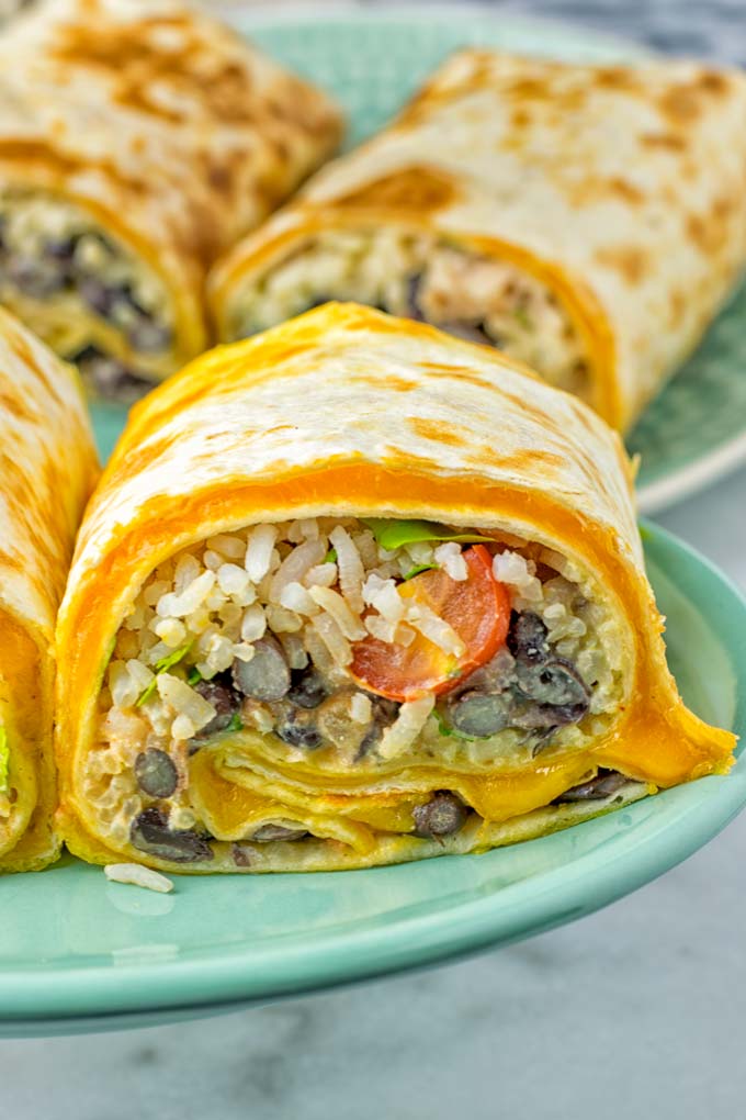 This Rice and Beans Quesarito is entirelly vegan, gluten free and so easy to make. It's cheesy, incredibly satisfying and so delicious for dinner, lunch, meal prep (reheat beautifully) and amazing for work lunches. An amazing dairy free alternative for everyone that the whole family will love. #vegan #glutenfree #dairyfree #vegetarian #contentednesscooking #quesarito #riceandbeans #dinner #lunch #worklunchideas #mealprep #quesadila #burrito