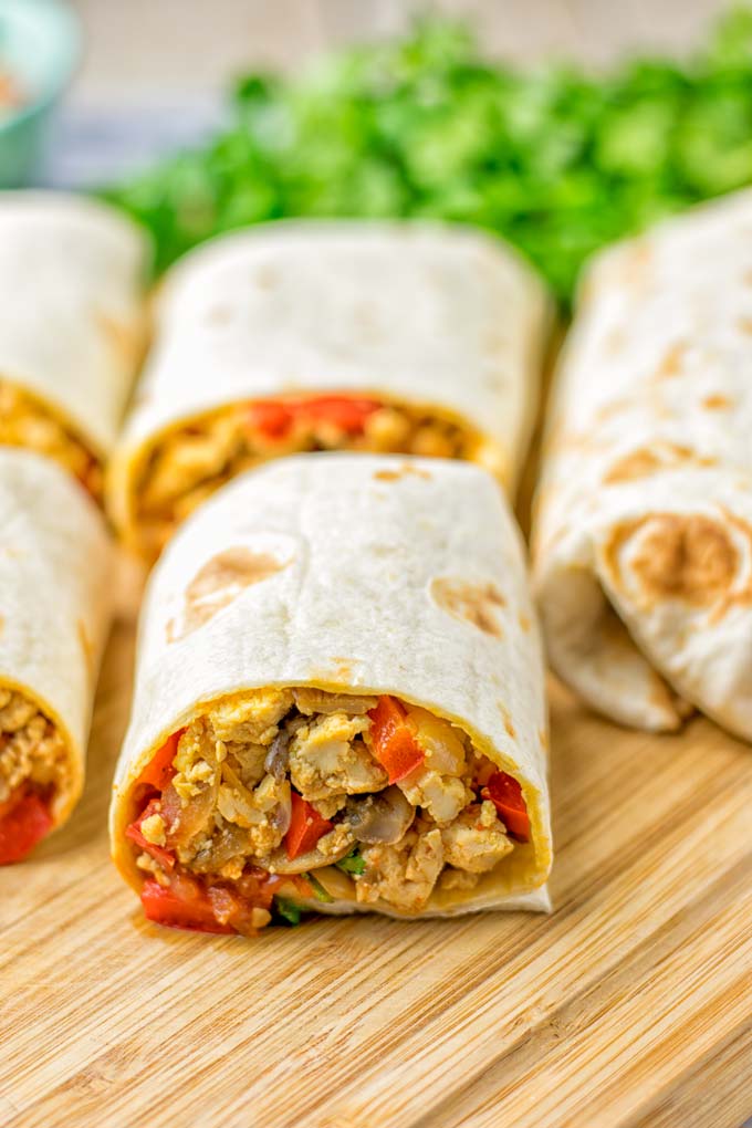 This Vegan Breakfast Burrito with Tofu Scramble is super easy to make and seriously the best burritos you've ever made and tasted. No one would guess it's entirely vegan, gluten free and your family won't miss the cheese or meat in these. These are also an amazing pick for meal prep, dinner, lunch, work lunch and so much more. #vegan #dairyfree #glutenfree #contentednesscooking #breakfastburritos #tofuscramble #breakfastideas #budgetmeals #dinner #lunch #mealprep #worklunchideas
