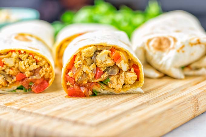 This Vegan Breakfast Burrito with Tofu Scramble is super easy to make and seriously the best burritos you've ever made and tasted. No one would guess it's entirely vegan, gluten free and your family won't miss the cheese or meat in these. These are also an amazing pick for meal prep, dinner, lunch, work lunch and so much more. #vegan #dairyfree #glutenfree #contentednesscooking #breakfastburritos #tofuscramble #breakfastideas #budgetmeals #dinner #lunch #mealprep #worklunchideas
