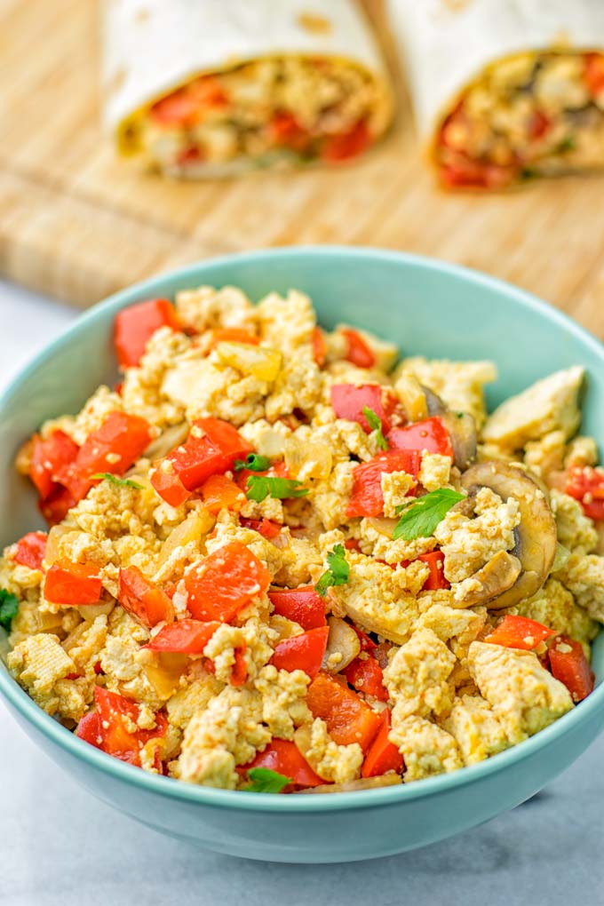 This Vegan Breakfast Burrito with Tofu Scramble is super easy to make and seriously the best burritos you've ever made and tasted. No one would guess it's entirely vegan, gluten free and your family won't miss the cheese or meat in these. These are also an amazing pick for meal prep, dinner, lunch, work lunch and so much more. #vegan #dairyfree #glutenfree #contentednesscooking #breakfastburritos #tofuscramble #breakfastideas #budgetmeals #dinner #lunch #mealprep #worklunchideas
