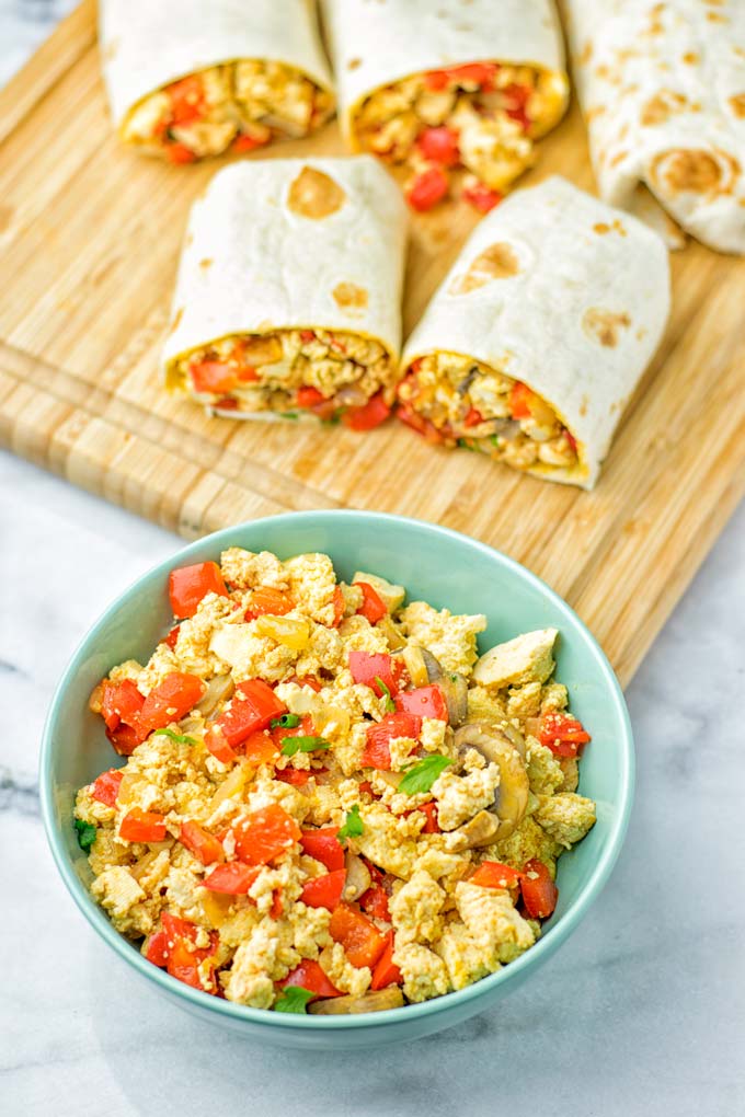 This Vegan Breakfast Burrito with Tofu Scramble is super easy to make and seriously the best burritos you've ever made and tasted. No one would guess it's entirely vegan, gluten free and your family won't miss the cheese or meat in these. These are also an amazing pick for meal prep, dinner, lunch, work lunch and so much more. #vegan #dairyfree #glutenfree #contentednesscooking #breakfastburritos #tofuscramble #breakfastideas #budgetmeals #dinner #lunch #mealprep #worklunchideas