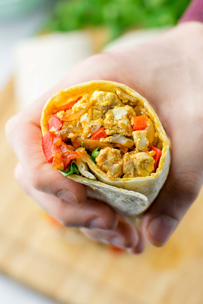 This Vegan Breakfast Burrito with Tofu Scramble is super easy to make and seriously the best burritos you've ever made and tasted. No one would guess it's entirely vegan, gluten free and your family won't miss the cheese or meat in these. These are also an amazing pick for meal prep, dinner, lunch, work lunch and so much more. #vegan #dairyfree #glutenfree #contentednesscooking #breakfastburritos #tofuscramble #breakfastideas #budgetmeals #dinner #lunch #mealprep #worklunchideas