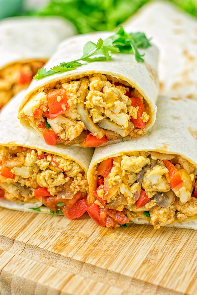 This Vegan Breakfast Burrito with Tofu Scramble is super easy to make and seriously the best burritos you've ever made and tasted. No one would guess it's entirely vegan, gluten free and your family won't miss the cheese or meat in these. These are also an amazing pick for meal prep, dinner, lunch, work lunch and so much more. #vegan #dairyfree #glutenfree #contentednesscooking #breakfastburritos #tofuscramble #breakfastideas #budgetmeals #dinner #lunch #mealprep #worklunchideas