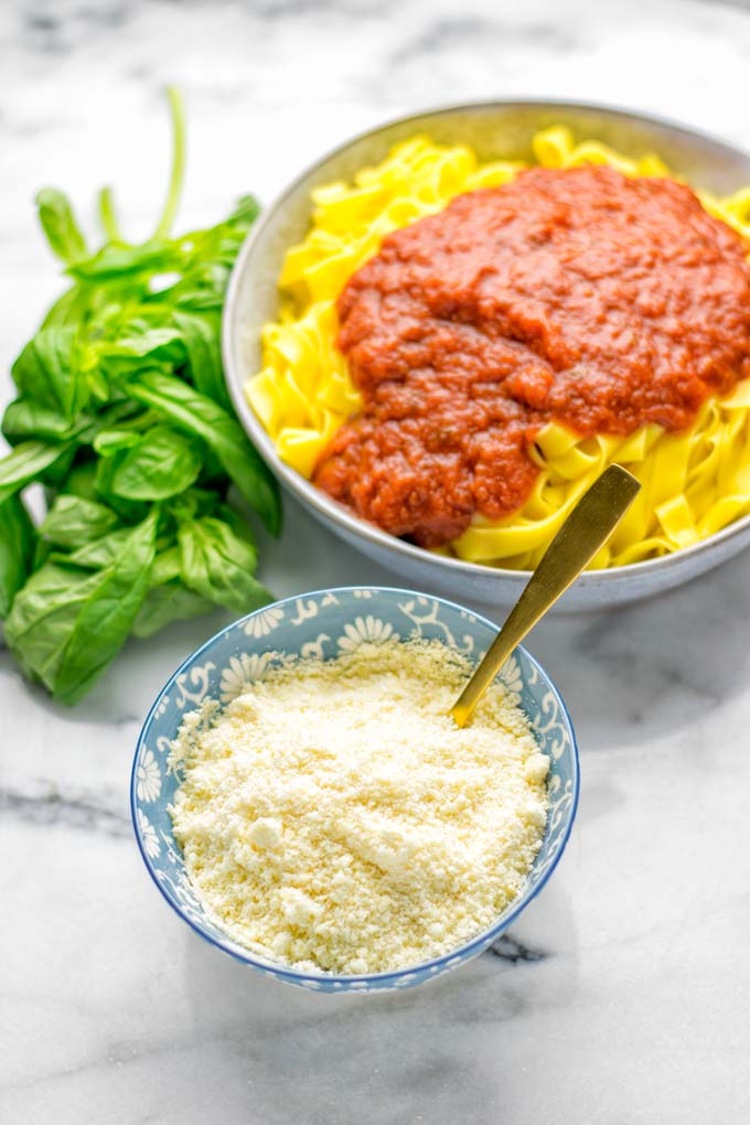 This Vegan Parmesan Cheese is made with super simple 3 ingredients in 1 minute. Trust me you really want this recipe - so versatile for all your pasta, casseroles, salads and so much more. It's a keeper for lunch, dinner, meal prep, work lunch that the whole family will love. #vegan #dairyfree #glutenfree #dinner #lunch #mealprep #worklunchideas #contentednesscooking #veganparmesancheese #pasta #pizza #casseroles #salads #familyfoodideas