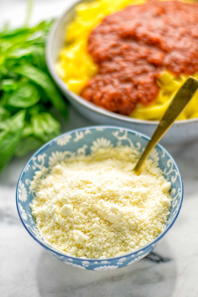 This Vegan Parmesan Cheese is made with super simple 3 ingredients in 1 minute. Trust me you really want this recipe - so versatile for all your pasta, casseroles, salads and so much more. It's a keeper for lunch, dinner, meal prep, work lunch that the whole family will love. #vegan #dairyfree #glutenfree #dinner #lunch #mealprep #worklunchideas #contentednesscooking #veganparmesancheese #pasta #pizza #casseroles #salads #familyfoodideas