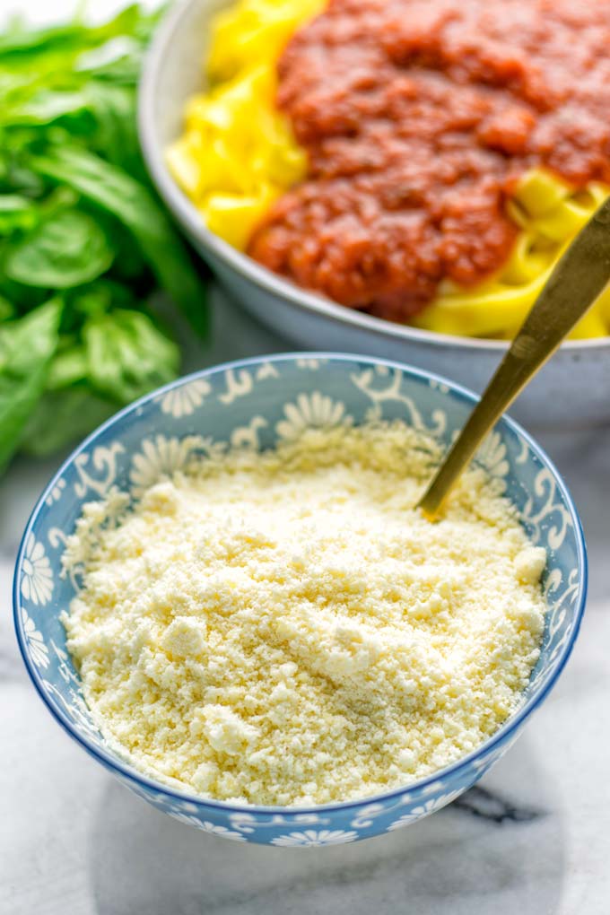This Vegan Parmesan Cheese is made with super simple 3 ingredients in 1 minute. Trust me you really want this recipe - so versatile for all your pasta, casseroles, salads and so much more. It's a keeper for lunch, dinner, meal prep, work lunch that the whole family will love. #vegan #dairyfree #glutenfree #dinner #lunch #mealprep #worklunchideas #contentednesscooking #veganparmesancheese #pasta #pizza #casseroles #salads #familyfoodideas