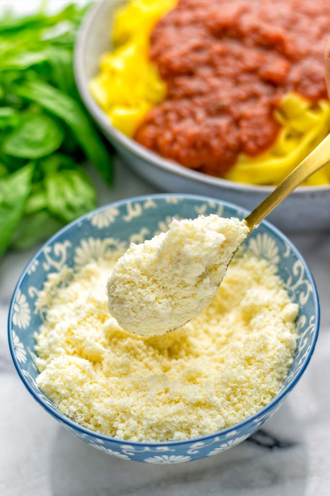 This Vegan Parmesan Cheese is made with super simple 3 ingredients in 1 minute. Trust me you really want this recipe - so versatile for all your pasta, casseroles, salads and so much more. It's a keeper for lunch, dinner, meal prep, work lunch that the whole family will love. #vegan #dairyfree #glutenfree #dinner #lunch #mealprep #worklunchideas #contentednesscooking #veganparmesancheese #pasta #pizza #casseroles #salads #familyfoodideas