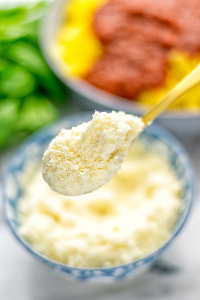This Vegan Parmesan Cheese is made with super simple 3 ingredients in 1 minute. Trust me you really want this recipe - so versatile for all your pasta, casseroles, salads and so much more. It's a keeper for lunch, dinner, meal prep, work lunch that the whole family will love. #vegan #dairyfree #glutenfree #dinner #lunch #mealprep #worklunchideas #contentednesscooking #veganparmesancheese #pasta #pizza #casseroles #salads #familyfoodideas