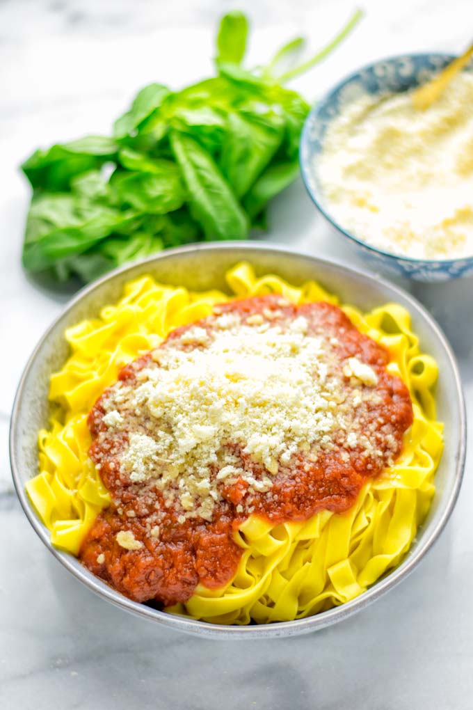 This Vegan Parmesan Cheese is made with super simple 3 ingredients in 1 minute. Trust me you really want this recipe - so versatile for all your pasta, casseroles, salads and so much more. It's a keeper for lunch, dinner, meal prep, work lunch that the whole family will love. #vegan #dairyfree #glutenfree #dinner #lunch #mealprep #worklunchideas #contentednesscooking #veganparmesancheese #pasta #pizza #casseroles #salads #familyfoodideas