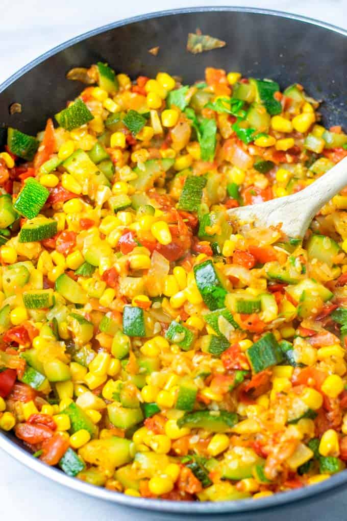 Wooden spoon in a pan with Calabacitas.