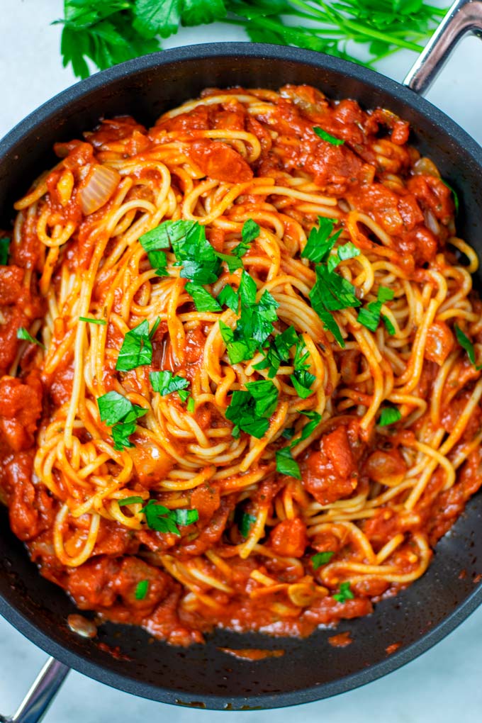 Top view on the Spaghetti Sauce mixed with pasta in a pan.