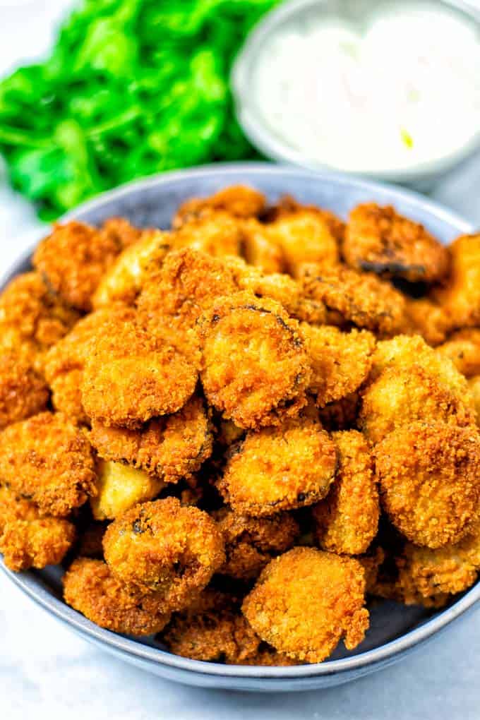 Top view on a plate full of Fried Pickles.