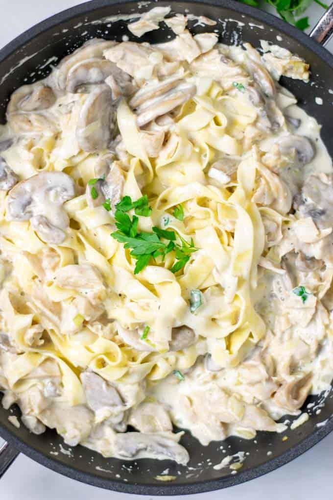 Top view of the Creamy Mushrooms mixed with pasta in a pan.