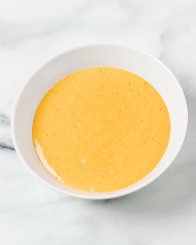 A white bowl with the ready Boom Boom Sauce.