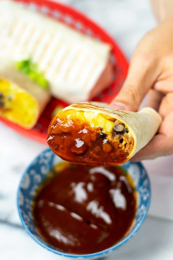 A piece of the French Taco after dipping in BBQ sauce.