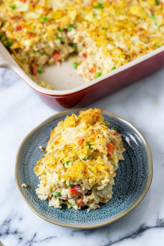 A portion of the Chicken and Rice Casserole on a small plate in front of the casserole dish.
