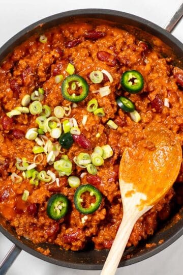 Texas Chili Beans are garnished with green onions an jalapeños.