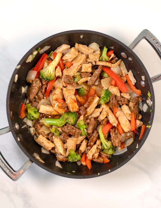 Adding the sauce ingredients to the stir fry.