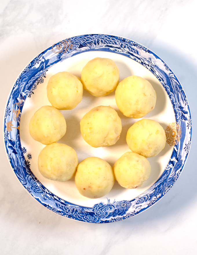 A large plate of Puerto Rican Stuffed Potato Balls before frying.