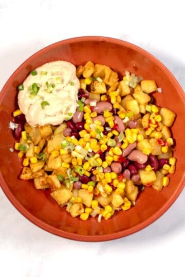 Fresh scallions are used to garnish Potato Bowl.