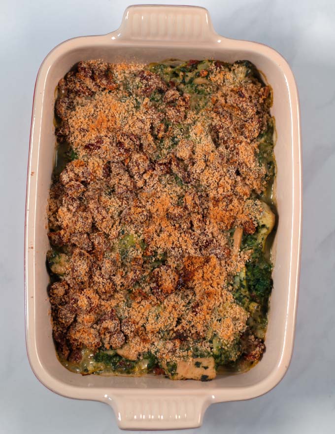Top view of a baking dish with ready Chicken Artichoke Casserole.