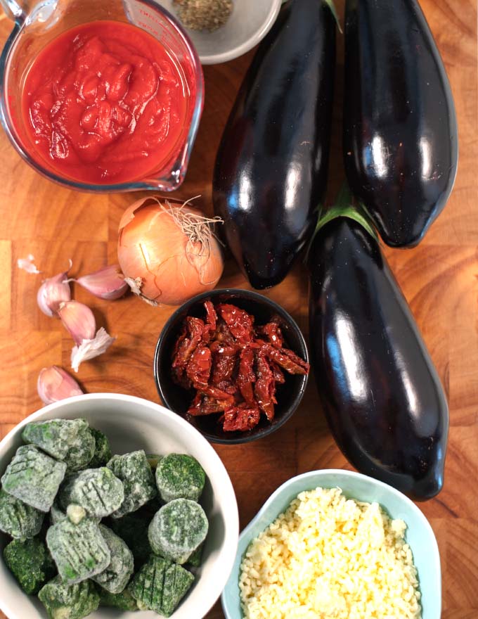Ingredients needed to make Eggplant Casserole collected on a board.