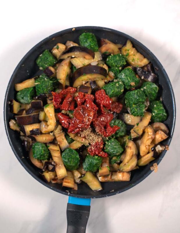 Spinach and sun-dried tomatoes are added to the eggplant.