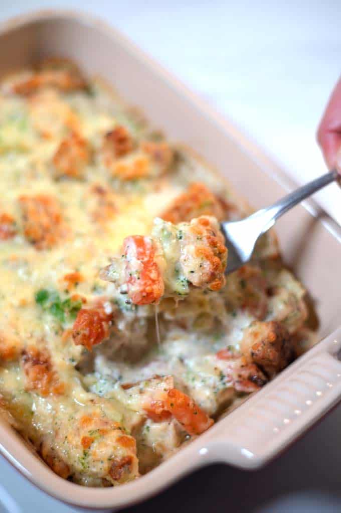 A fork lifts a bite of the Keto Chicken Vegetable Casserole.